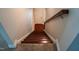 Carpeted stairs with a wooden banister lead down into the basement of this warm, inviting home at 825 Fulworth Ave, Wake Forest, NC 27587