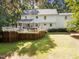 Spacious backyard featuring a multi-level deck with hot tub, lounge seating, and manicured lawn at 8909 Wellsley Way, Raleigh, NC 27613