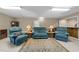 Finished basement showcasing comfortable blue armchairs, area rug, and classic furniture pieces at 8909 Wellsley Way, Raleigh, NC 27613