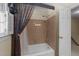 Bathroom with shower-tub combination and tiled walls at 8909 Wellsley Way, Raleigh, NC 27613