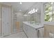 Bright bathroom with a glass-enclosed shower and marble countertops at 8909 Wellsley Way, Raleigh, NC 27613