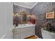 Charming powder room with patterned wallpaper, vanity, mirror, and fixtures at 8909 Wellsley Way, Raleigh, NC 27613