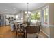 Cozy breakfast nook featuring a round table, bay window, and views of the backyard and an open kitchen area at 8909 Wellsley Way, Raleigh, NC 27613