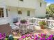 Spacious back deck perfect for entertaining with outdoor seating and colorful flowers at 8909 Wellsley Way, Raleigh, NC 27613