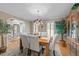 Charming dining room with hardwood floors, stylish chandelier and large windows at 8909 Wellsley Way, Raleigh, NC 27613