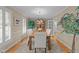 Elegant dining room featuring hardwood floors, large windows, and a stylish chandelier at 8909 Wellsley Way, Raleigh, NC 27613