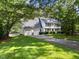 Beautiful two-story home with a well-manicured lawn, a two car garage and mature trees at 8909 Wellsley Way, Raleigh, NC 27613