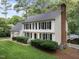 A classic white two story home shows off mature landscaping and black window shutters at 8909 Wellsley Way, Raleigh, NC 27613