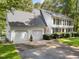 Exterior view of a two story home with a three car garage, driveway, and manicured landscaping at 8909 Wellsley Way, Raleigh, NC 27613