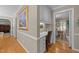 Hallway featuring a built-in desk area, hardwood floors, and doorways leading to other rooms in the home at 8909 Wellsley Way, Raleigh, NC 27613