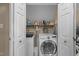 Functional laundry closet with modern washer and dryer, shelving, and ample storage space at 8909 Wellsley Way, Raleigh, NC 27613