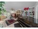 Cozy living room with a fireplace, built-in bookshelves, and a grand piano at 8909 Wellsley Way, Raleigh, NC 27613