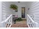 Inviting front porch with a bench, hanging flowers, and a charming welcome at 8909 Wellsley Way, Raleigh, NC 27613