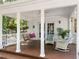 Relaxing covered porch featuring rocking chairs and a swing for outdoor enjoyment at 8909 Wellsley Way, Raleigh, NC 27613