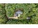 Aerial view showcasing a brick home surrounded by lush greenery and mature trees at 901 Tamaras Cir, Wake Forest, NC 27587