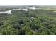 Scenic aerial of a house nestled among trees, located near a body of water, showcasing a serene setting at 901 Tamaras Cir, Wake Forest, NC 27587