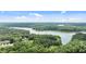 Secluded residence featuring mature trees and lush landscaping on a lake at 901 Tamaras Cir, Wake Forest, NC 27587