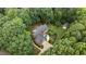 Aerial view of the brick home surrounded by lush landscaping and mature trees at 901 Tamaras Cir, Wake Forest, NC 27587