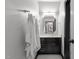 Bathroom features a black vanity, marble countertop, hexagon tile floor, and decorative mirror at 901 Tamaras Cir, Wake Forest, NC 27587