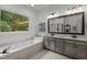 Spacious bathroom featuring a soaking tub, double sinks, and large mirror at 901 Tamaras Cir, Wake Forest, NC 27587