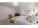 Bright bedroom with large windows, vintage dresser, and neutral color palette at 901 Tamaras Cir, Wake Forest, NC 27587