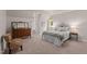 Bright bedroom with large windows, patterned chair, and neutral color palette at 901 Tamaras Cir, Wake Forest, NC 27587