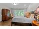 Comfortable bedroom featuring hardwood floors and a bay window with backyard views at 901 Tamaras Cir, Wake Forest, NC 27587