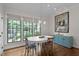 Light-filled dining area showcases an oval table, decorative lighting, and views to the backyard at 901 Tamaras Cir, Wake Forest, NC 27587