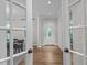 Elegant foyer with hardwood floors, decorative columns, and a view into the adjacent dining room at 901 Tamaras Cir, Wake Forest, NC 27587