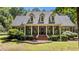 Charming brick home with a welcoming front porch and well-manicured landscaping at 901 Tamaras Cir, Wake Forest, NC 27587