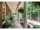 Spacious front porch featuring classic rocking chairs and lush hanging plants, perfect for relaxation at 901 Tamaras Cir, Wake Forest, NC 27587