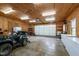 Spacious garage featuring wood paneled walls and ample storage at 901 Tamaras Cir, Wake Forest, NC 27587