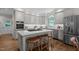 Kitchen island with gas cooktop has seating, offering prep and entertaining space at 901 Tamaras Cir, Wake Forest, NC 27587