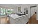 Kitchen island boasts gas cooktop and marble countertop; lovely eat-in kitchen area in background at 901 Tamaras Cir, Wake Forest, NC 27587
