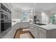 Spacious open kitchen design with stainless appliances, white cabinets and island cooktop at 901 Tamaras Cir, Wake Forest, NC 27587