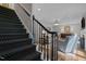 View from the stairs to the living room with fireplace and hardwood floors at 901 Tamaras Cir, Wake Forest, NC 27587