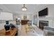 Bright living room features fireplace, TV, elegant lighting, and comfortable seating at 901 Tamaras Cir, Wake Forest, NC 27587