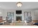 Comfortable living room features a fireplace, TV, neutral tones and lots of natural light at 901 Tamaras Cir, Wake Forest, NC 27587