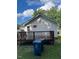 View of a white house with a backyard wooden deck and trash cans at 906 Camden Ave, Durham, NC 27701