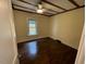 Cozy bedroom featuring hardwood floors and a window providing natural light at 906 Camden Ave, Durham, NC 27701