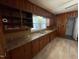 A kitchen featuring wood walls, neutral floors, and ample counter space at 906 Camden Ave, Durham, NC 27701