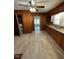 Bright kitchen with a ceiling fan, wood cabinets, and wood paneling at 906 Camden Ave, Durham, NC 27701