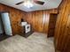 A kitchen featuring wood walls, neutral floors, and an adjacent doorway at 906 Camden Ave, Durham, NC 27701