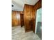 A kitchen featuring wood walls, tile floors, and access to another room at 906 Camden Ave, Durham, NC 27701