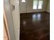 View of a living room with hardwood floors and natural lighting shining through windows at 906 Camden Ave, Durham, NC 27701