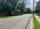 A road surrounded by lush greenery and trees, showcasing the neighborhood's peaceful environment at 906 Camden Ave, Durham, NC 27701