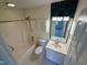 Bright bathroom has teal accent wall tile, a tub/shower combo, and a single vanity at 922 Edgewater Cir, Chapel Hill, NC 27516