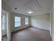 Bright and sunny room with neutral walls and carpet with lots of natural light from two windows at 922 Edgewater Cir, Chapel Hill, NC 27516
