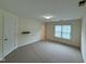 Spacious carpeted bedroom with large windows, a floating shelf, and neutral paint at 922 Edgewater Cir, Chapel Hill, NC 27516