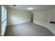 Spacious carpeted room with white walls, a large window, and multiple doors at 922 Edgewater Cir, Chapel Hill, NC 27516